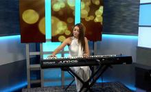 Miss Aurora 2024 playing the piano in AuroraTV studio